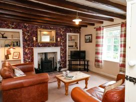 A living room with a sofa and coffee table at 5 Hollins Cottages, Whitby