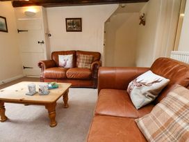 A living room with sofas and a coffee table at 5 Hollins Cottages in Whitby
