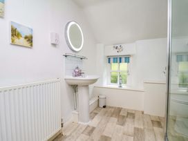 A bathroom with a sink and shower at 5 Hollins Cottages in Whitby