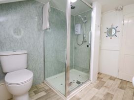 A bathroom with a shower and toilet at 5 Hollins Cottages in Whitby