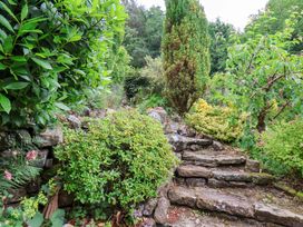 A garden with stone steps and various plants at 5 Hollins Cottages in Whitby