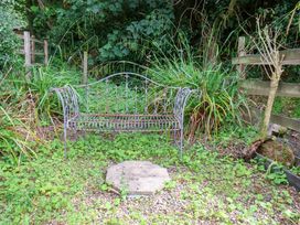 A garden with a bench and stone slab at 5 Hollins Cottages in Whitby