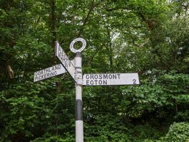 A signpost showing directions to various locations at 5 Hollins Cottages in Whitby