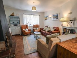 A living room with sofas and a coffee table at Buttercup in Blakeney, Norfolk