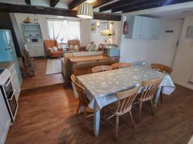 A dining room with a table and chairs at Buttercup in Blakeney, Norfolk