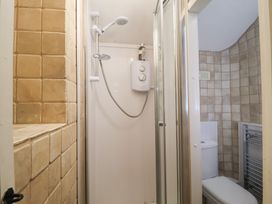 A bathroom with a shower and toilet at Buttercup in Blakeney, Norfolk