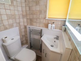 A bathroom with a toilet and sink at Buttercup in Blakeney, Norfolk