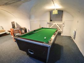 A game room with a pool table and seating at Buttercup in Blakeney, Norfolk