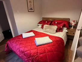 A bedroom with a bed and bedside table at The Bittern in Blakeney, Norfolk