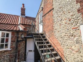 An outdoor staircase leading to a door at The Plover in Blakeney, Norfolk