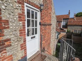 An exterior door with steps and a pebble wall at The Plover Blakeney, Norfolk