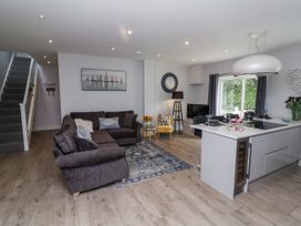 A living room with a sofa and kitchen island at Beach Hideaway