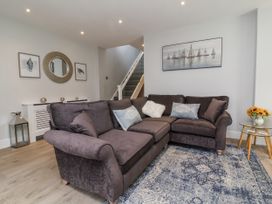 A living room with a sofa and carpet at Beach Hideaway