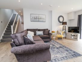 A living room with a sofa and television at Beach Hideaway