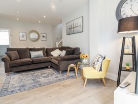 A living room with a sofa and side table at Beach Hideaway