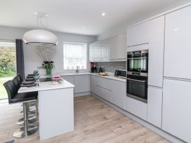 A kitchen with cabinets and appliances at Beach Hideaway
