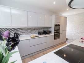 A kitchen with cabinets and appliances at Beach Hideaway