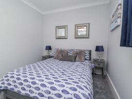 A bedroom with a bed and two bedside tables at Beach Hideaway