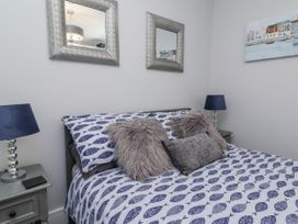 A bedroom with a bed and mirrors at Beach Hideaway