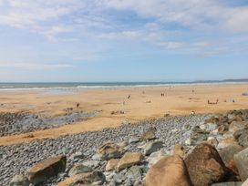 A beach view with people and rocks at Beach Hideaway