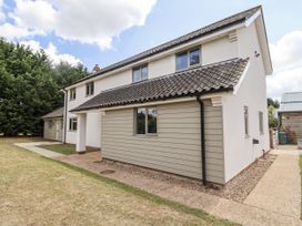 A house exterior with windows and a pathway at Holly Farm Colchester