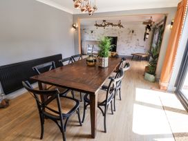 A dining room with a table and chairs at Holly Farm in Colchester