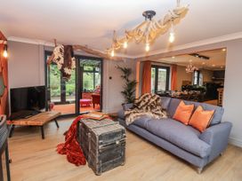 A living room with a sofa and television at Holly Farm in Brantham