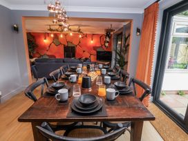 A dining room with a table set for meals at Holly Farm in Brantham