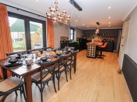A dining room with a table set for breakfast at Holly Farm in Brantham
