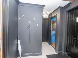 A hallway with an umbrella and a door at Holly Farm in Brantham