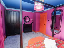 A bedroom with a bed and wardrobe at Holly Farm in Brantham