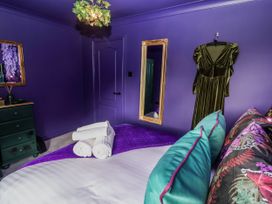 A bedroom with a bed and towels at Holly Farm in Brantham