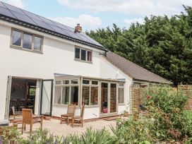 A house exterior with solar panels and patio furniture at Holly Farm in Brantham