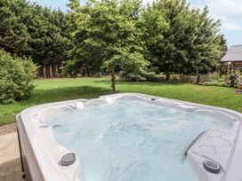 A hot tub in a garden at Holly Farm in Brantham
