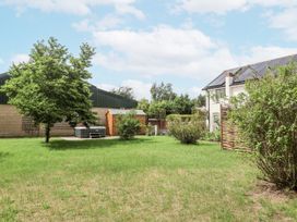 A garden with a tree and shed at Holly Farm in Brantham