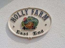 A sign displaying Holly Farm with a rooster at Holly Farm in Brantham