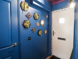 An entryway with decorative wall art and a door at Annexe in Colchester