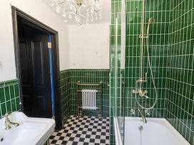 A bathroom with a bathtub and shower in Annexe Colchester
