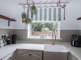 A kitchen with a sink and appliances at Annexe East End near Brantham