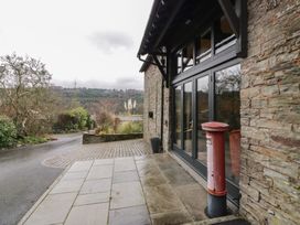 An outdoor view with a building entrance and a post box at The Barn at Sunny Barn Brecon