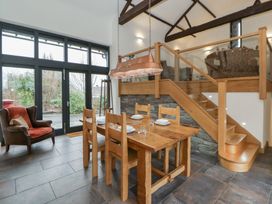 A dining room with a table and chairs at The Barn at Sunny Barn Brecon
