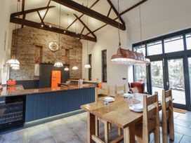 A kitchen with a large table and chairs at The Barn at Sunny Barn in Brecon