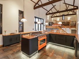 A kitchen with an island and stove at The Barn at Sunny Barn in Brecon