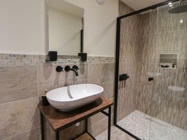 A bathroom with a sink and shower at The Barn at Sunny Barn in Brecon