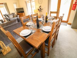 A dining area with a table set for meals at Sunnyside Lodge in Thorpe-On-The-Hill