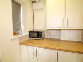 A kitchen with a microwave and sink at Sunnyside Lodge Thorpe-On-The-Hill
