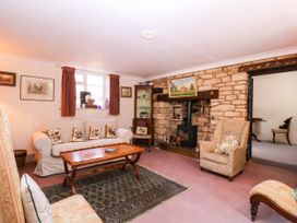 A living room with a sofa and coffee table at Vine Cottage in Cheltenham