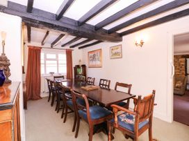A dining room with a table and chairs at Vine Cottage in Cheltenham
