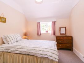 A bedroom with a bed and a chest of drawers at Vine Cottage in Cheltenham