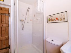 A bathroom with a shower and a toilet at Vine Cottage in Cheltenham